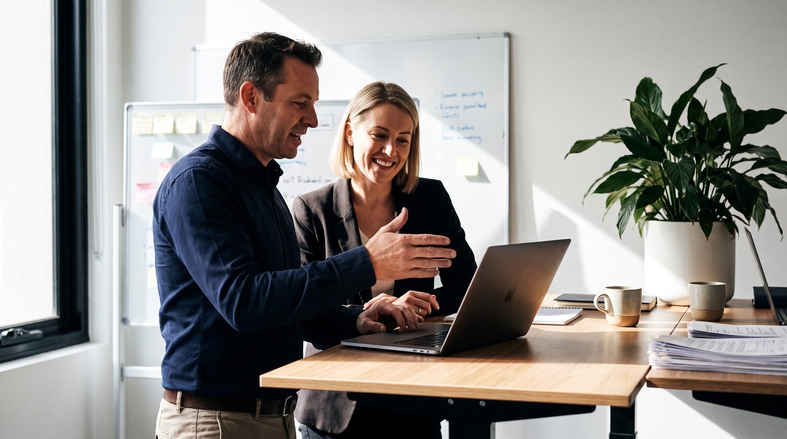 Two Australian finance brokers going through the imported Make scenario together on a laptop